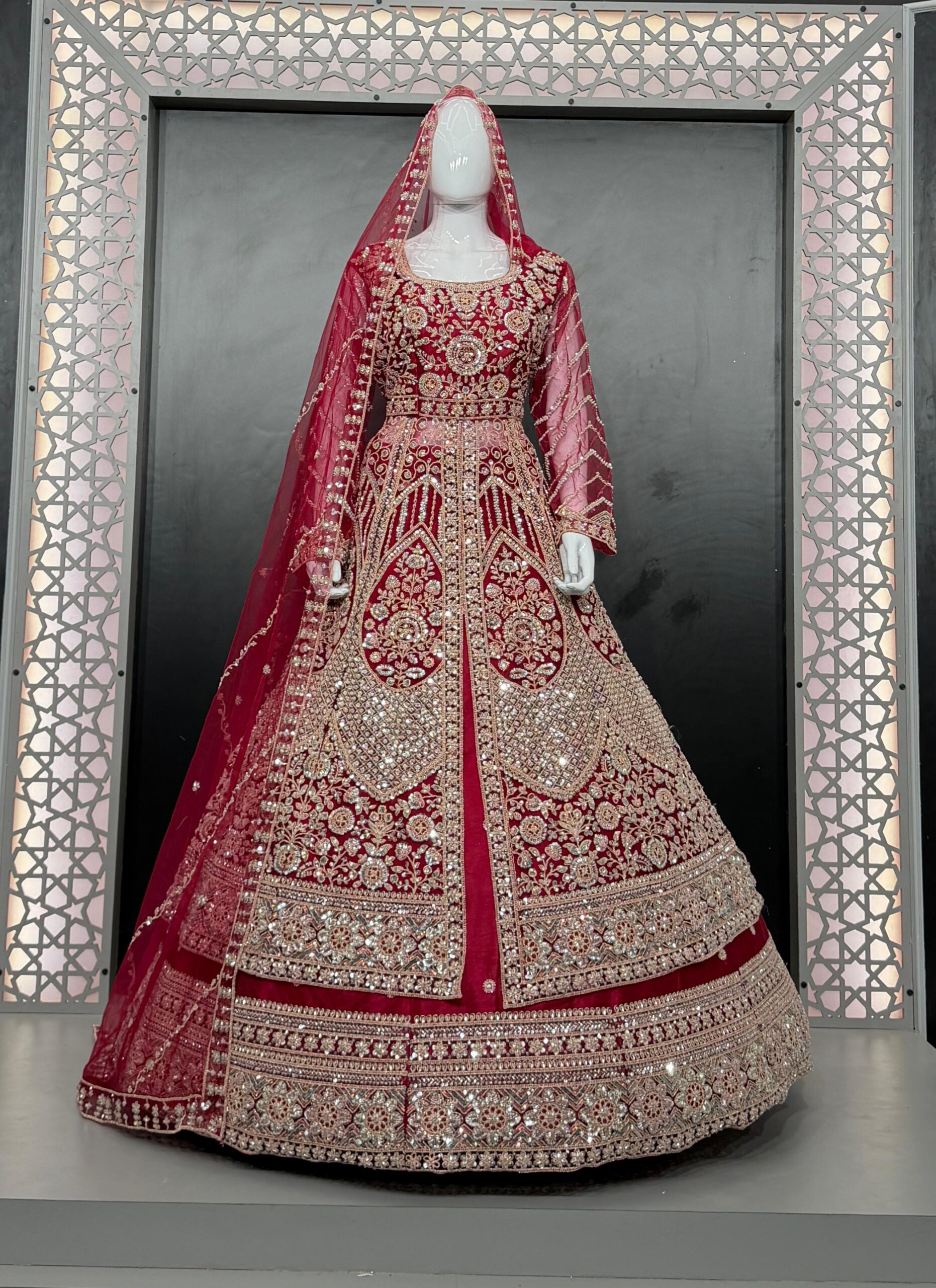 1001187461 Maroon bridal anarkali suit with heavy golden embroidery displayed on white mannequin in decorative frame