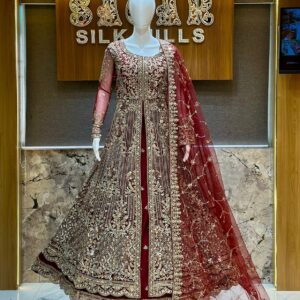 Maroon bridal lehenga with heavy gold embroidery and glass diamond work displayed on mannequin