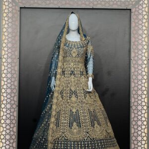 Navy blue dulhan lehenga with heavy golden embroidery displayed on mannequin in decorative frame