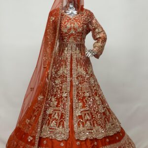 Red bridal lehenga with heavy gold zardozi embroidery displayed on mannequin with matching dupatta